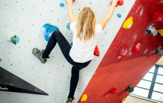 child climbing a climbing wall at top birthday party venues Toronto