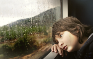 bored child by window wanting indoor spring activities