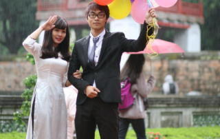 rained on summer event. Bride and groom in rain with balloons